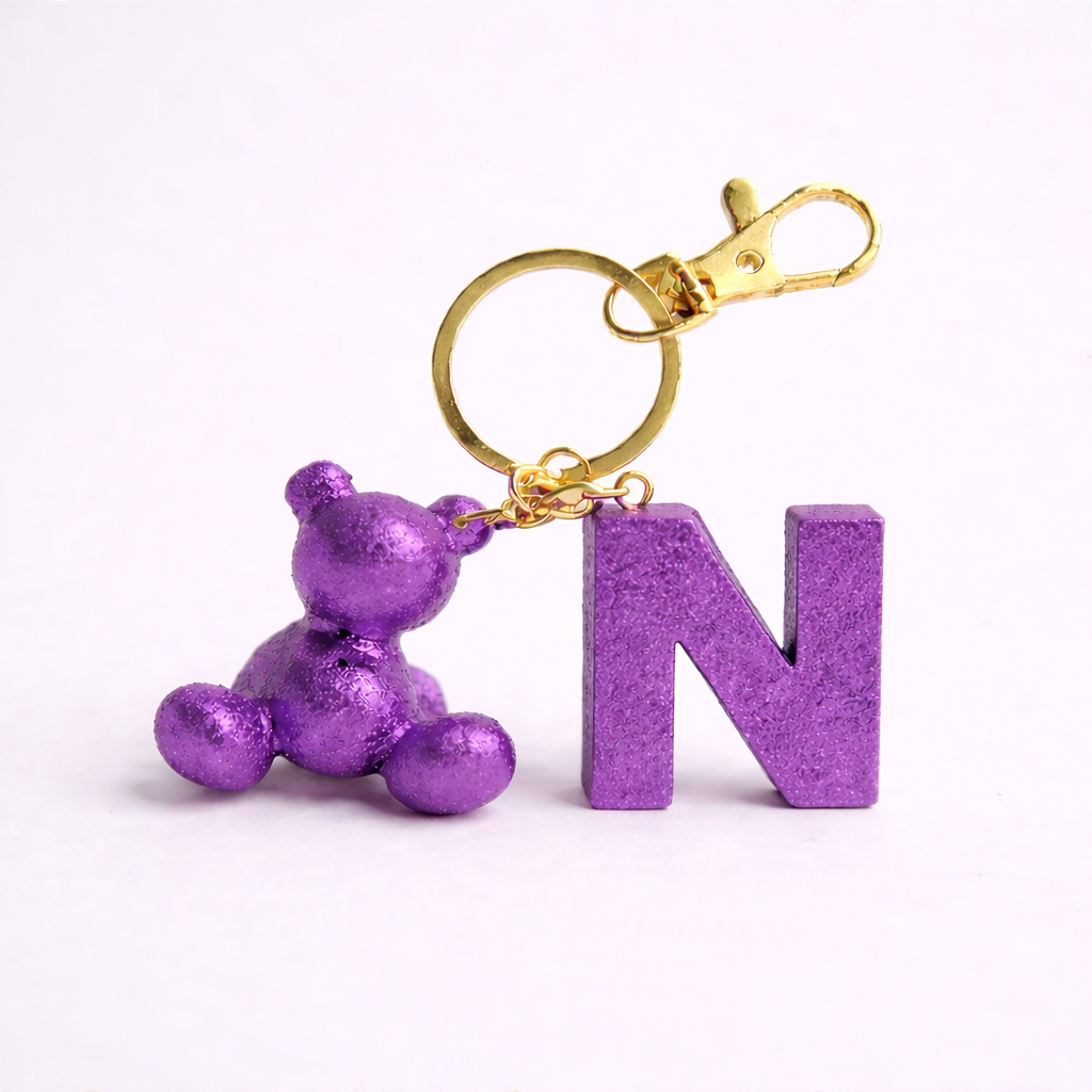 Purple handmade resin bear keychain with the letter N