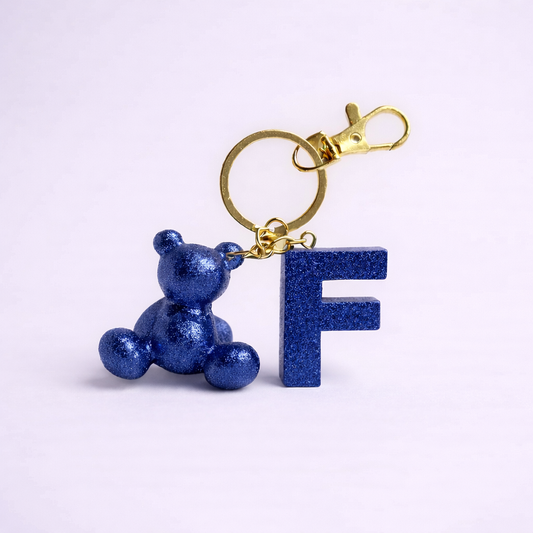 Blue handmade resin bear keychain with the letter F