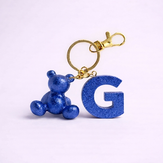 Blue handmade resin bear keychain with the letter G