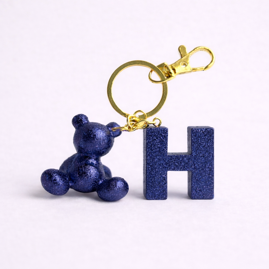 Blue handmade resin bear keychain with the letter H