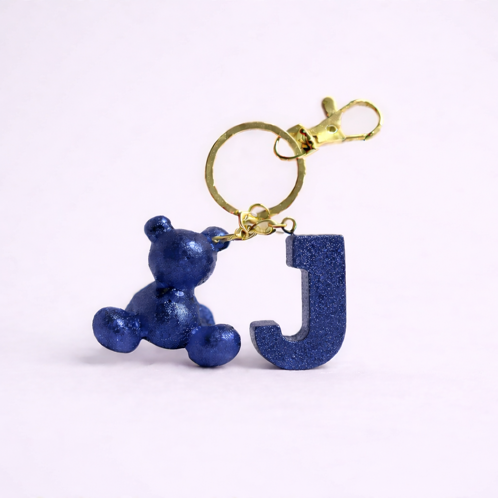 Blue handmade resin bear keychain with the letter J