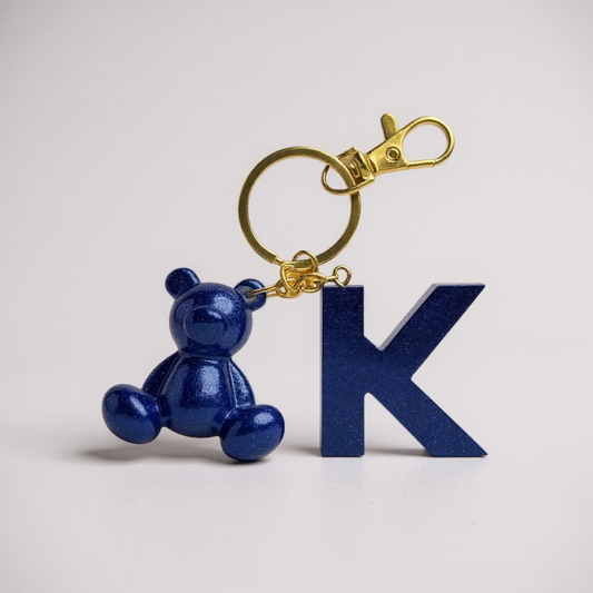 Blue handmade resin bear keychain with the letter K