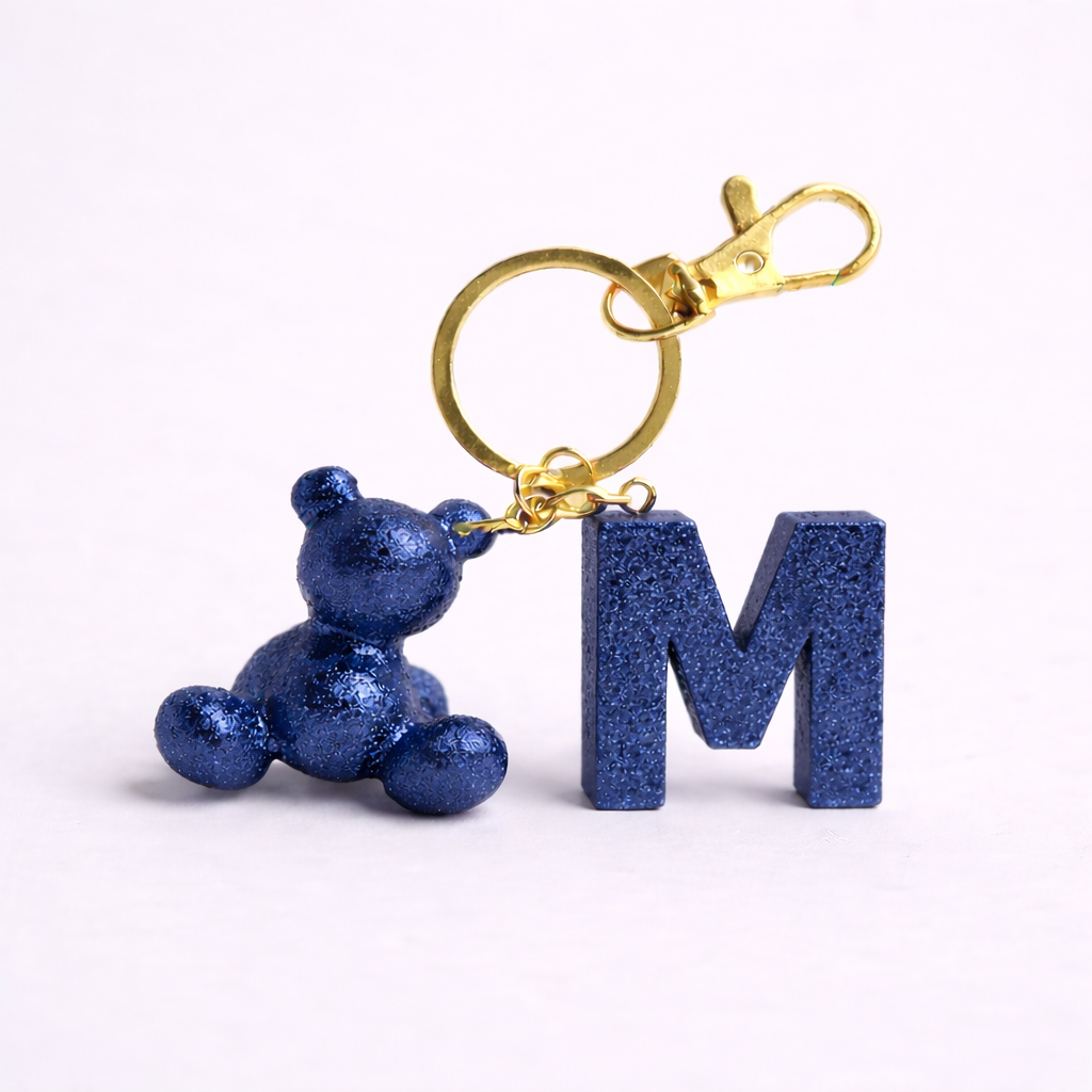 Blue handmade resin bear keychain with the letter M