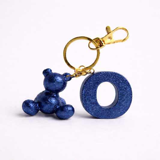 Blue handmade resin bear keychain with the letter O