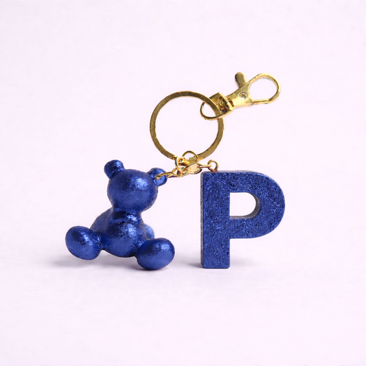 Blue handmade resin bear keychain with the letter P