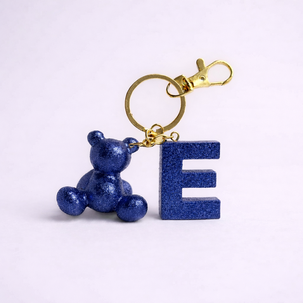 Blue handmade resin bear keychain with the letter E