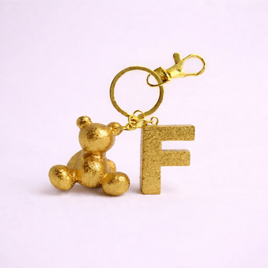 Gold handmade resin bear keychain with the letter F