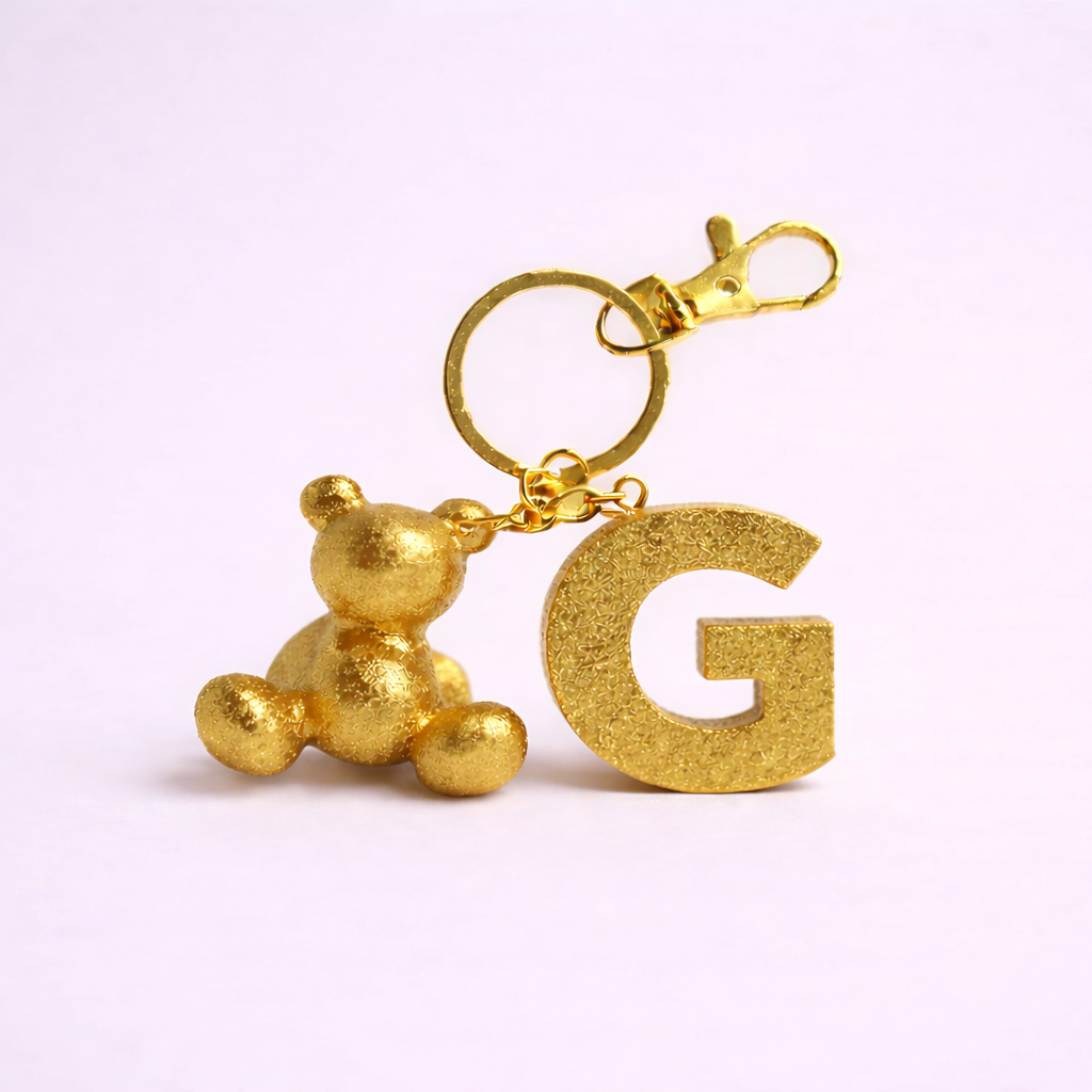 Gold handmade resin bear keychain with the letter G
