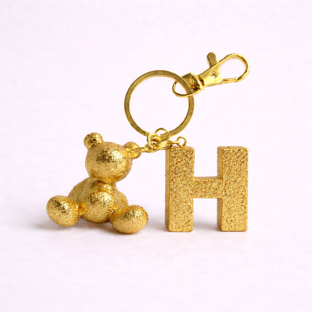 Gold handmade resin bear keychain with the letter H