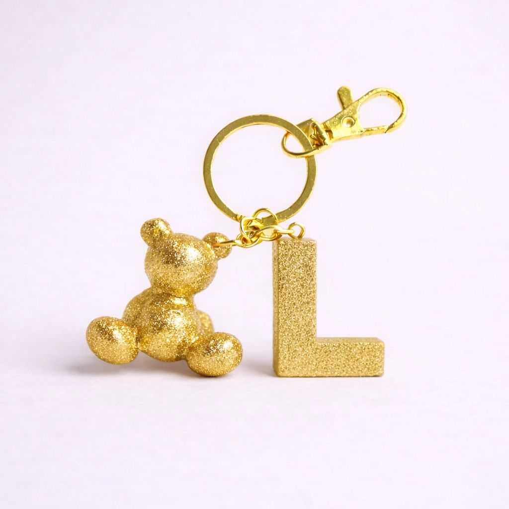 Gold handmade resin bear keychain with the letter L