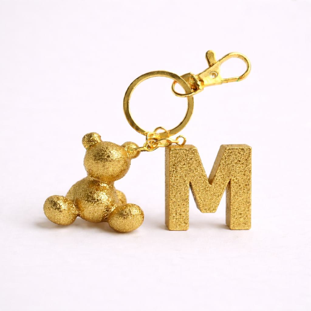 Gold handmade resin bear keychain with the letter M