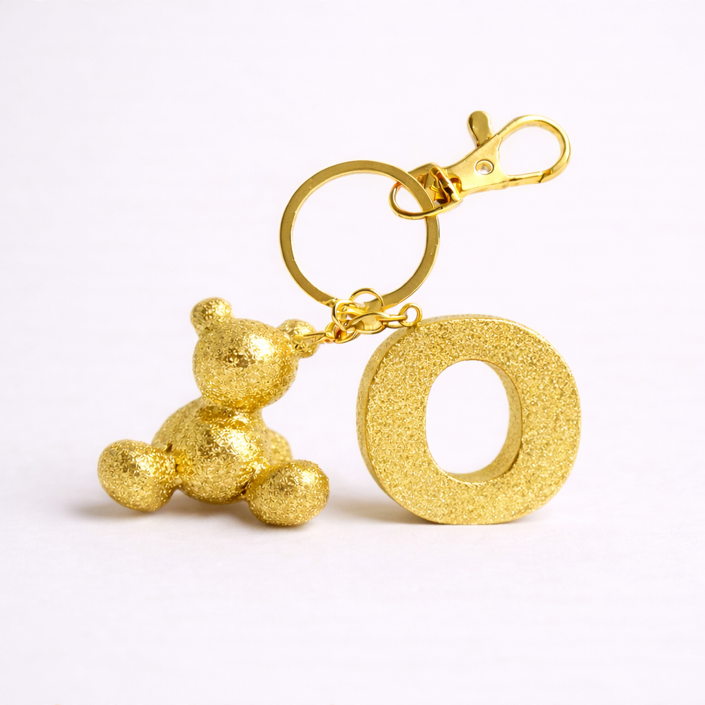 Gold handmade resin bear keychain with the letter O