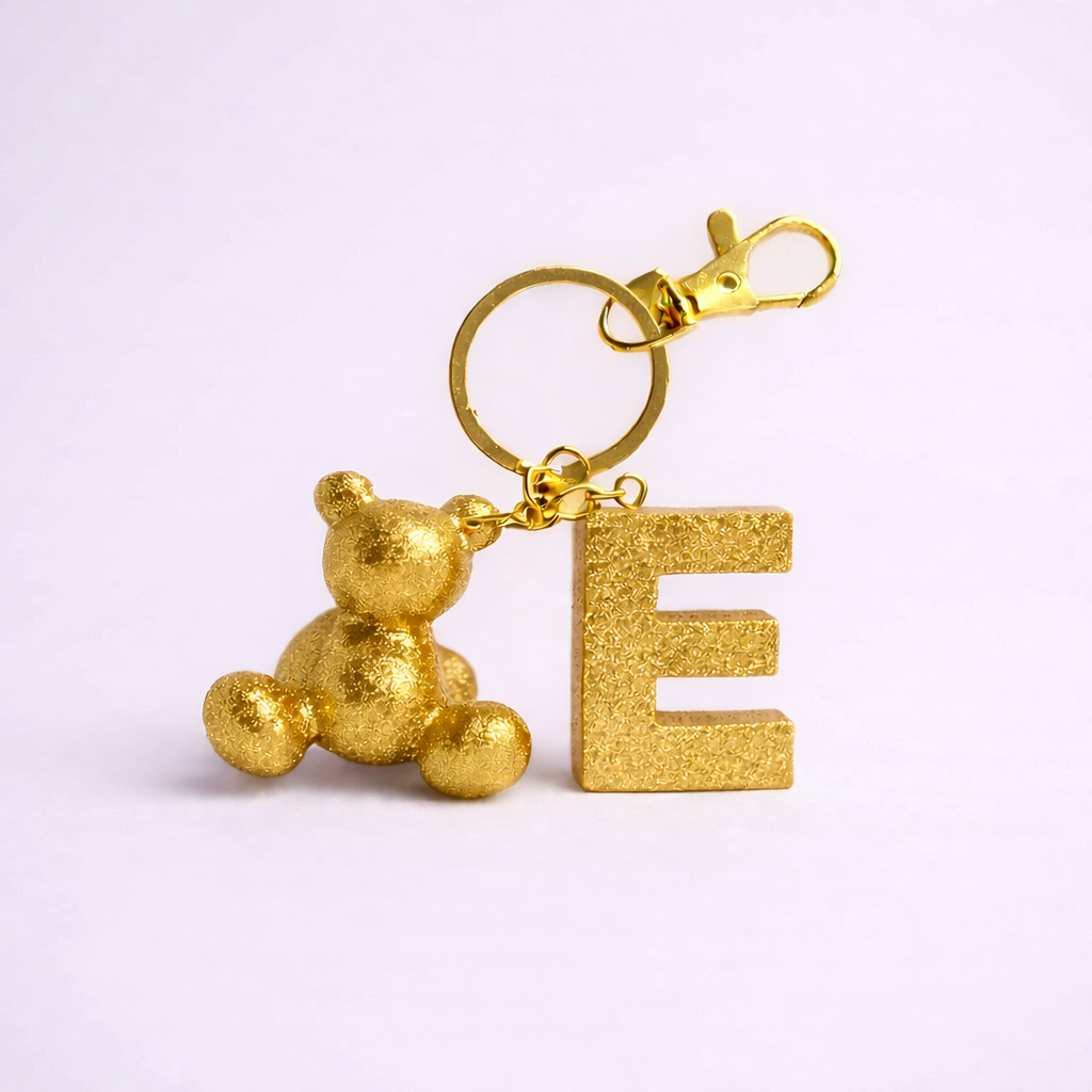 Gold handmade resin bear keychain with the letter E