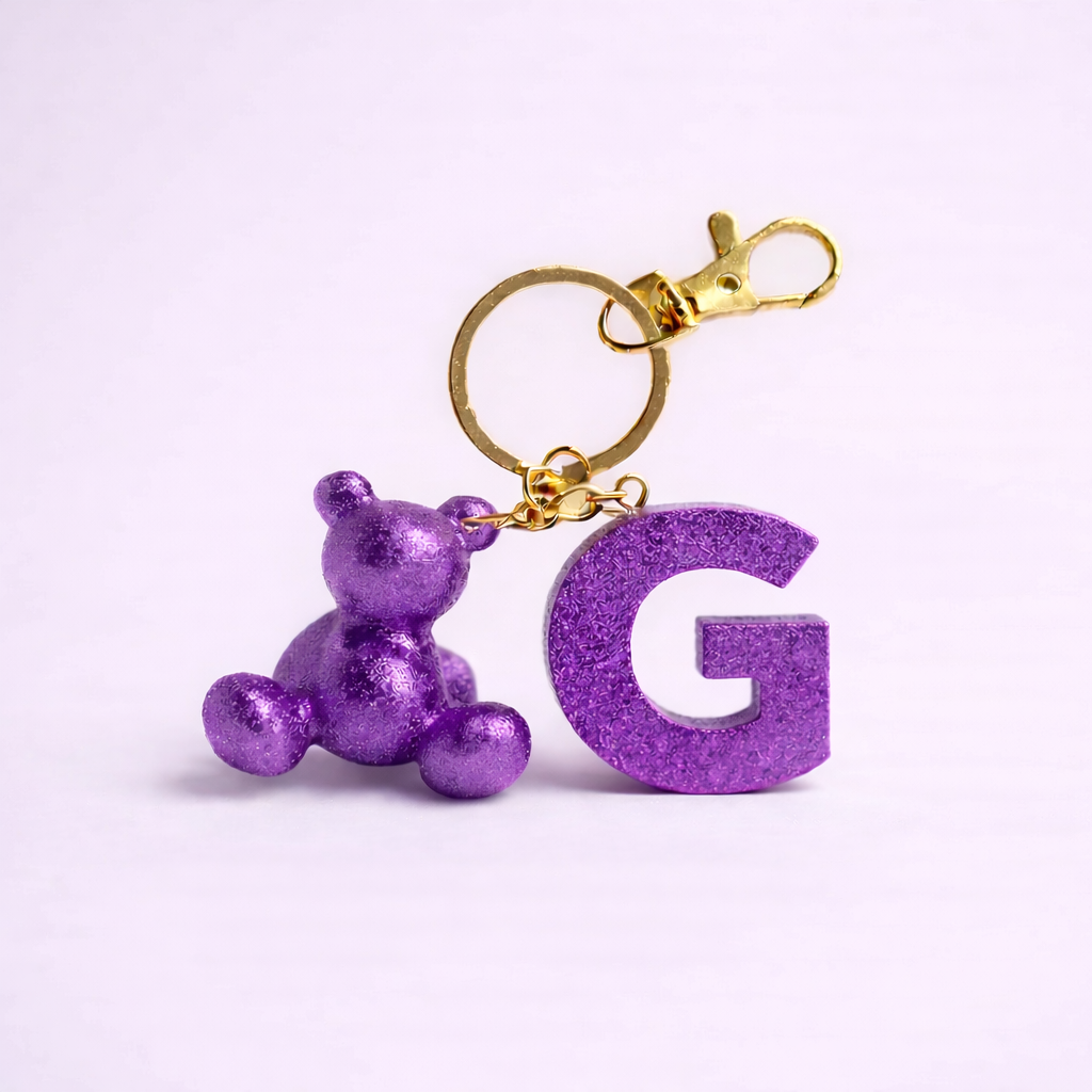 Purple handmade resin bear keychain with the letter G