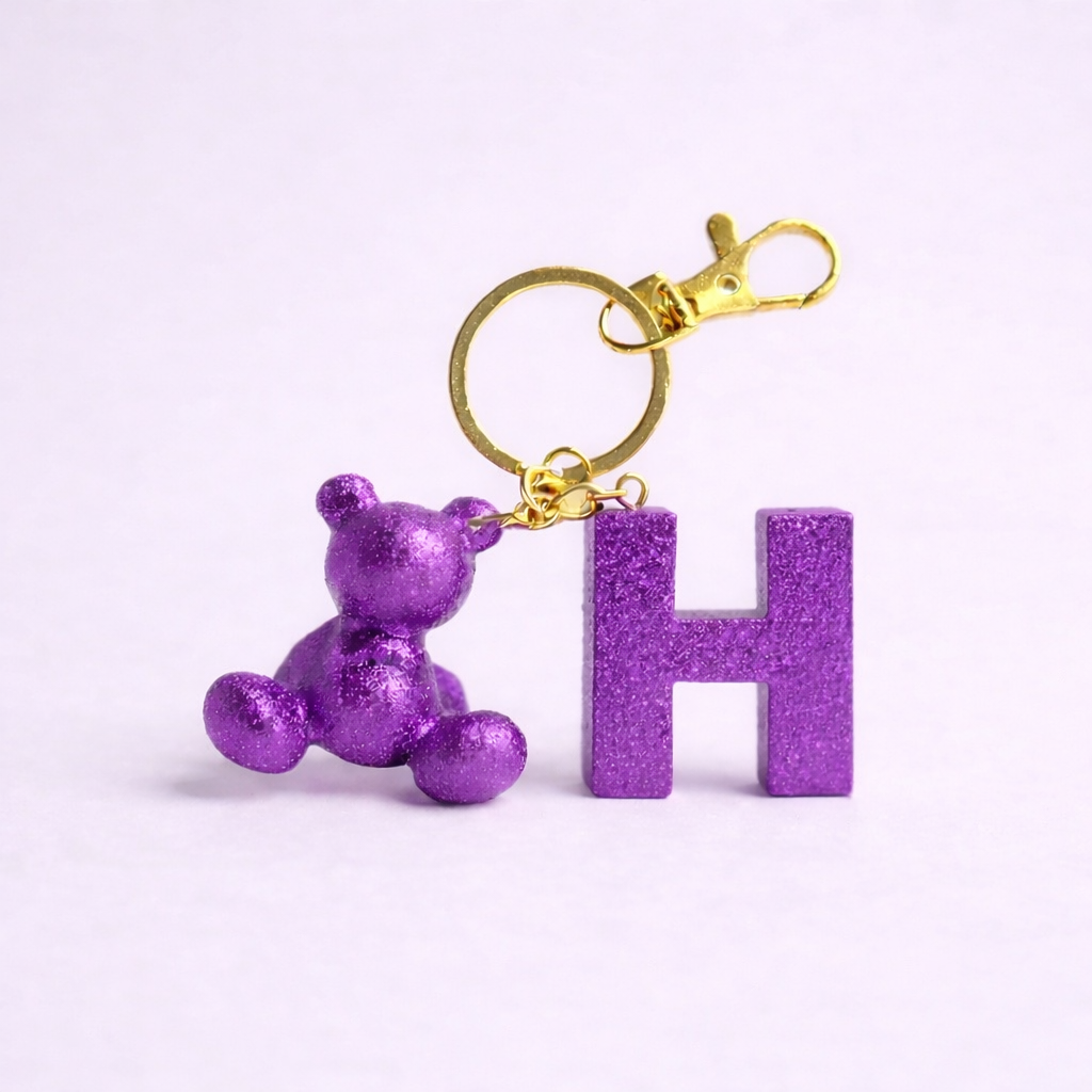 Purple handmade resin bear keychain with the letter H