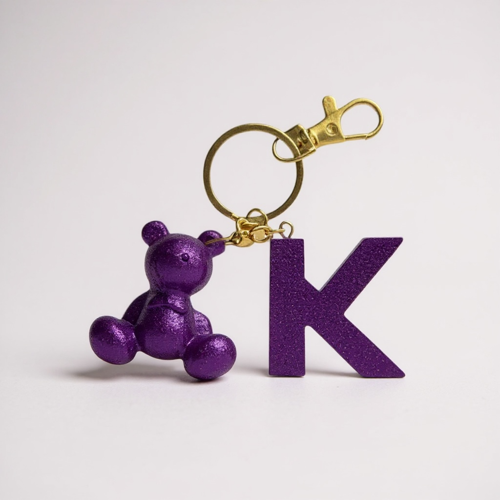 Purple handmade resin bear keychain with the letter K