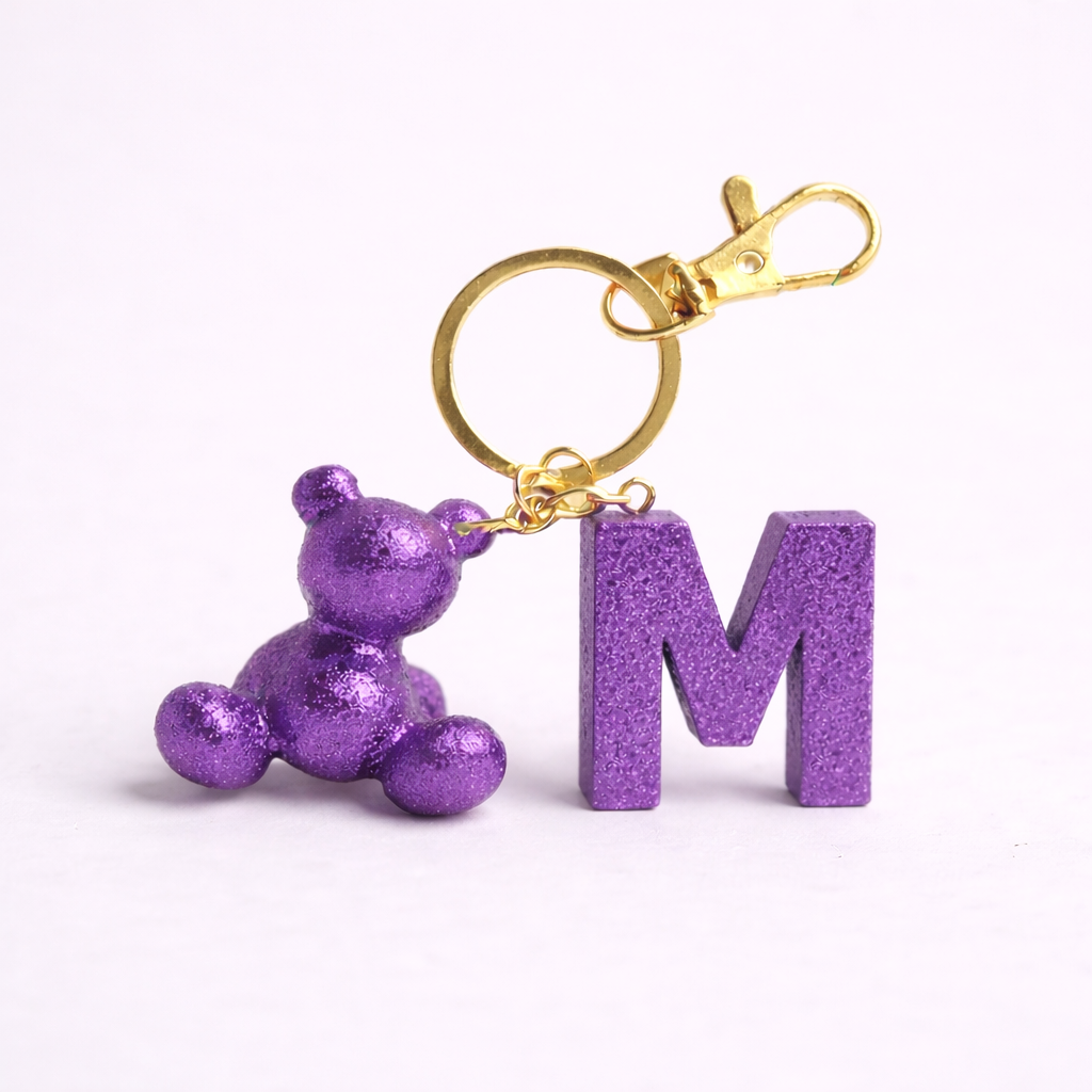 Purple handmade resin bear keychain with the letter M