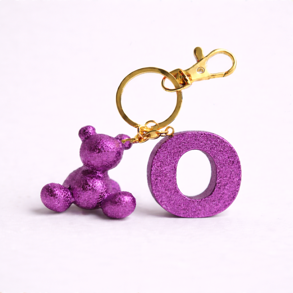 Purple handmade resin bear keychain with the letter O