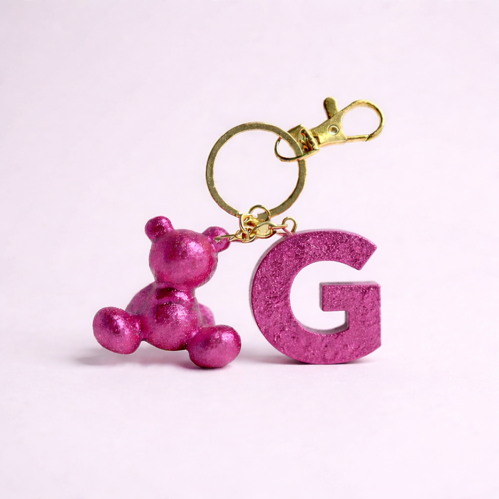 Pink handmade resin bear keychain with the letter G