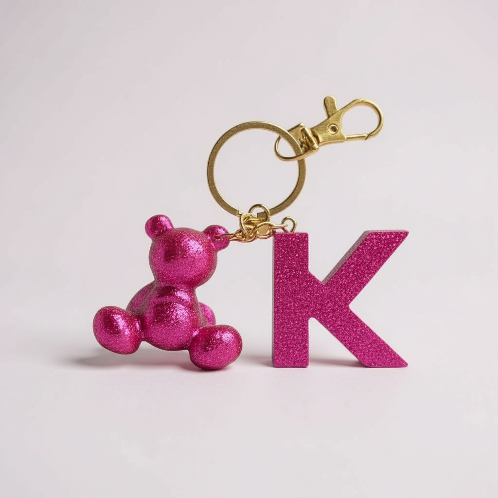 Pink handmade resin bear keychain with the letter K
