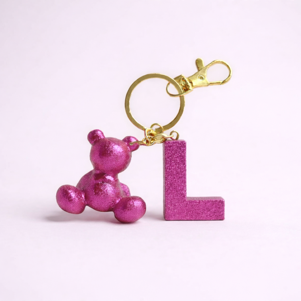 Pink handmade resin bear keychain with the letter L