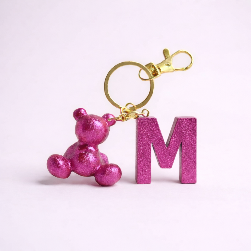 Pink handmade resin bear keychain with the letter M