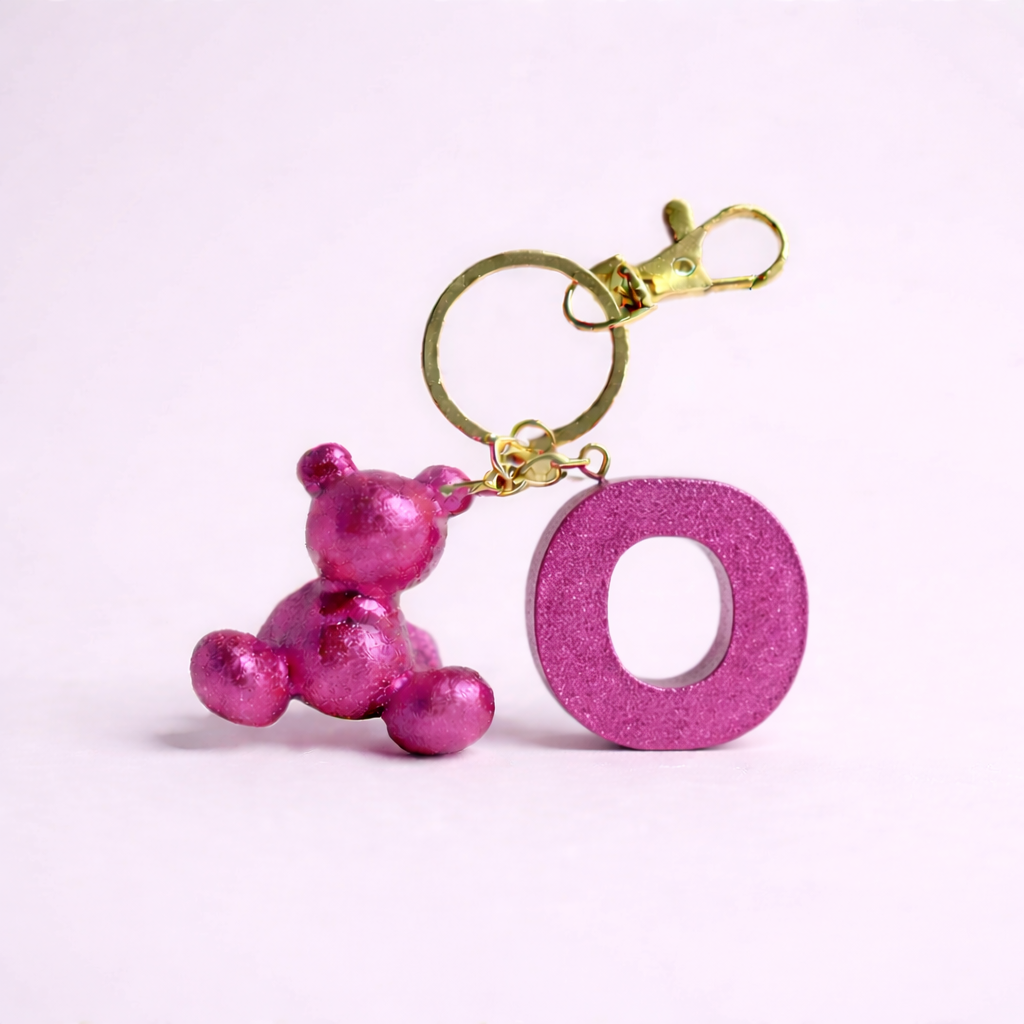 Pink handmade resin bear keychain with the letter O