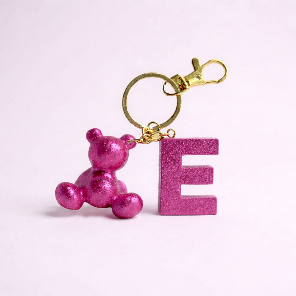 Pink handmade resin bear keychain with the letter E
