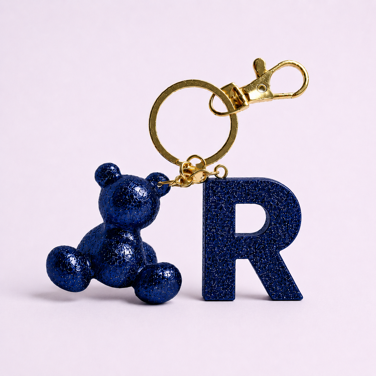 Blue handmade resin bear keychain with the letter R