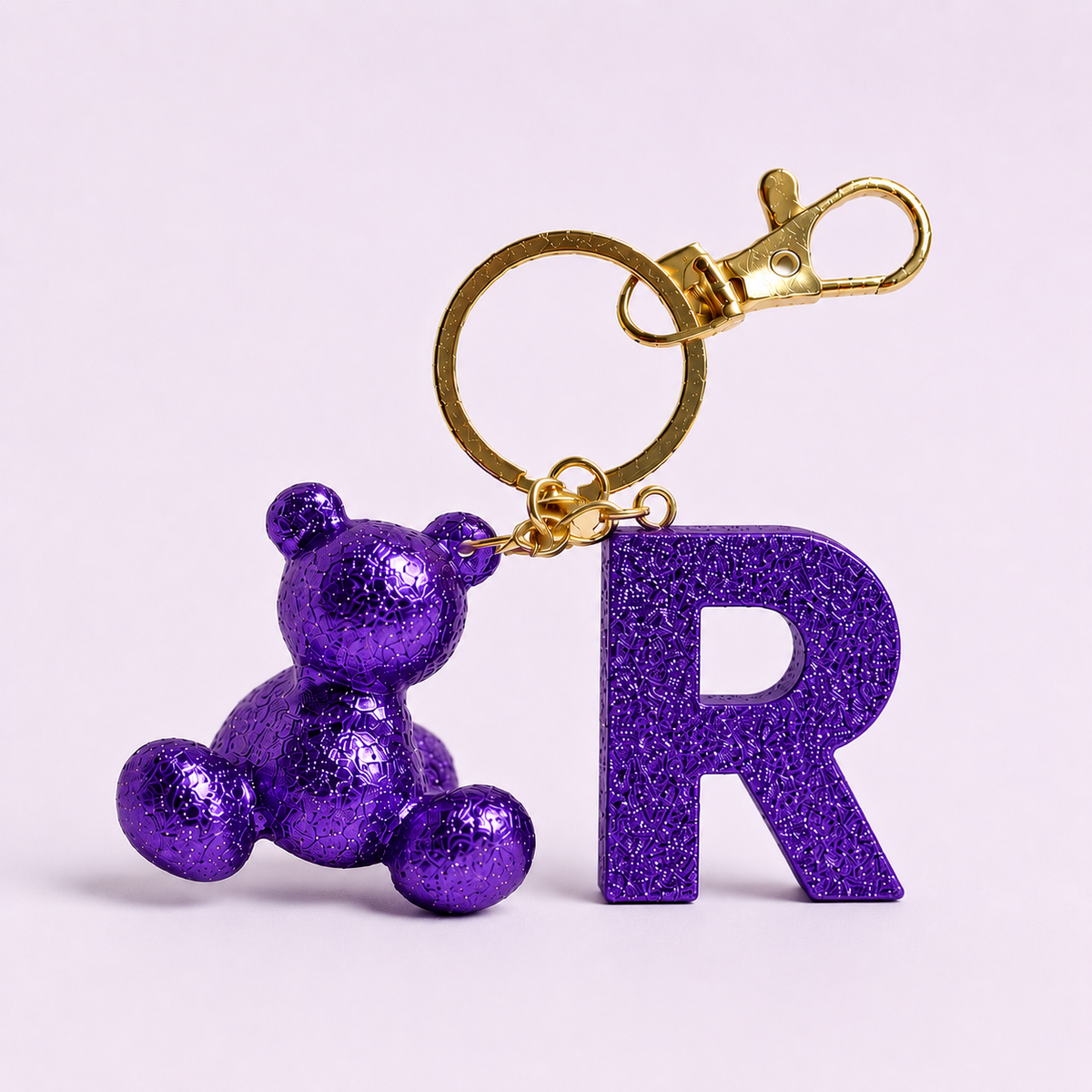 Purple handmade resin bear keychain with the letter R