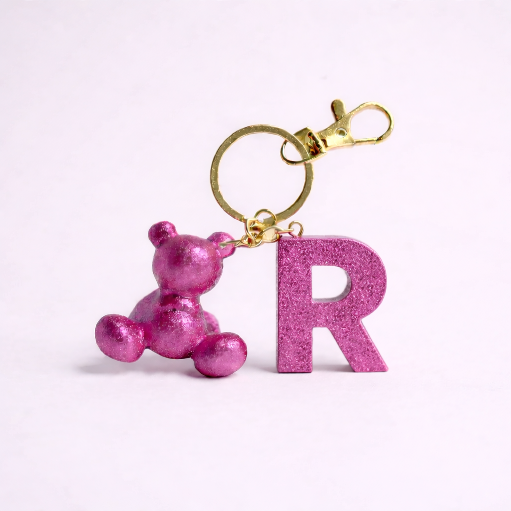 Pink handmade resin bear keychain with the letter R