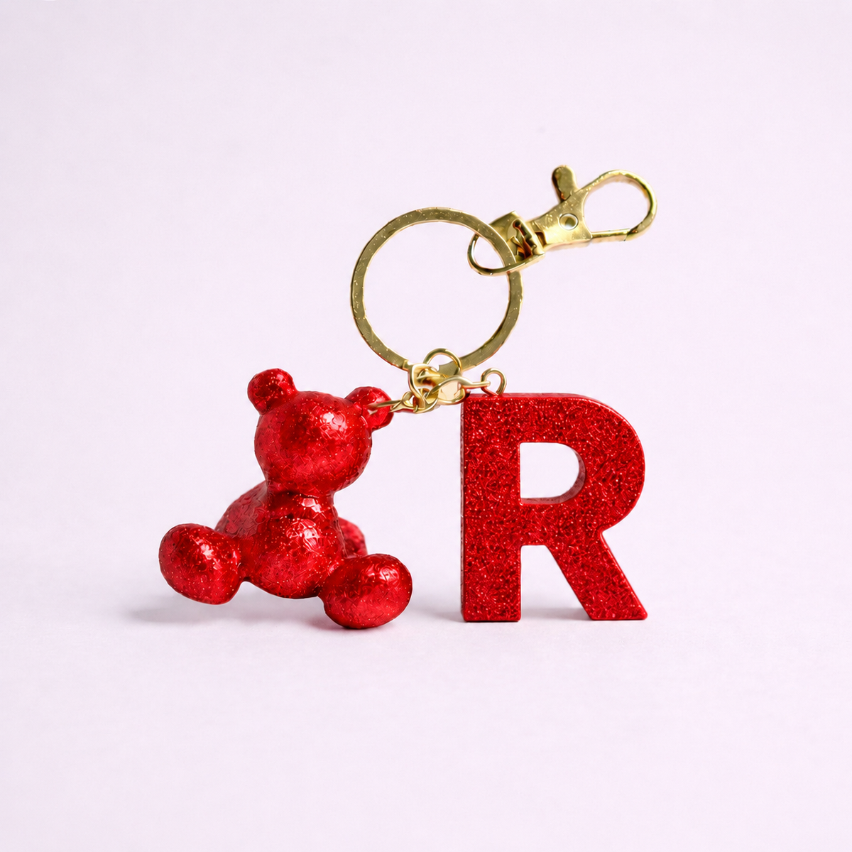 Red handmade resin bear keychain with the letter R