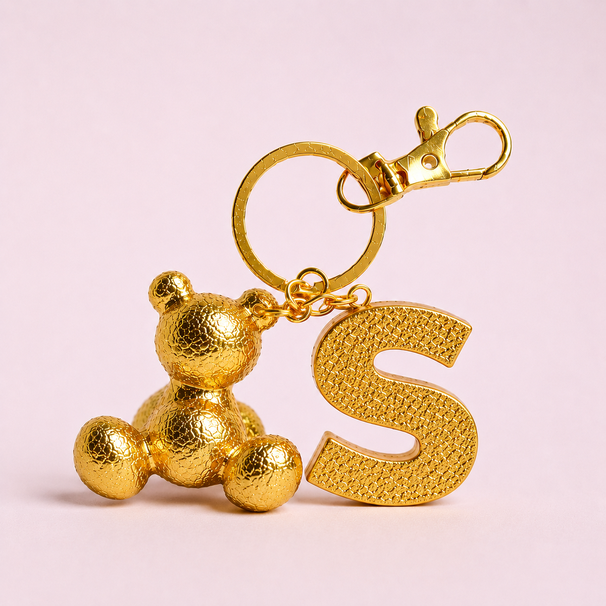 Gold handmade resin bear keychain with the letter S
