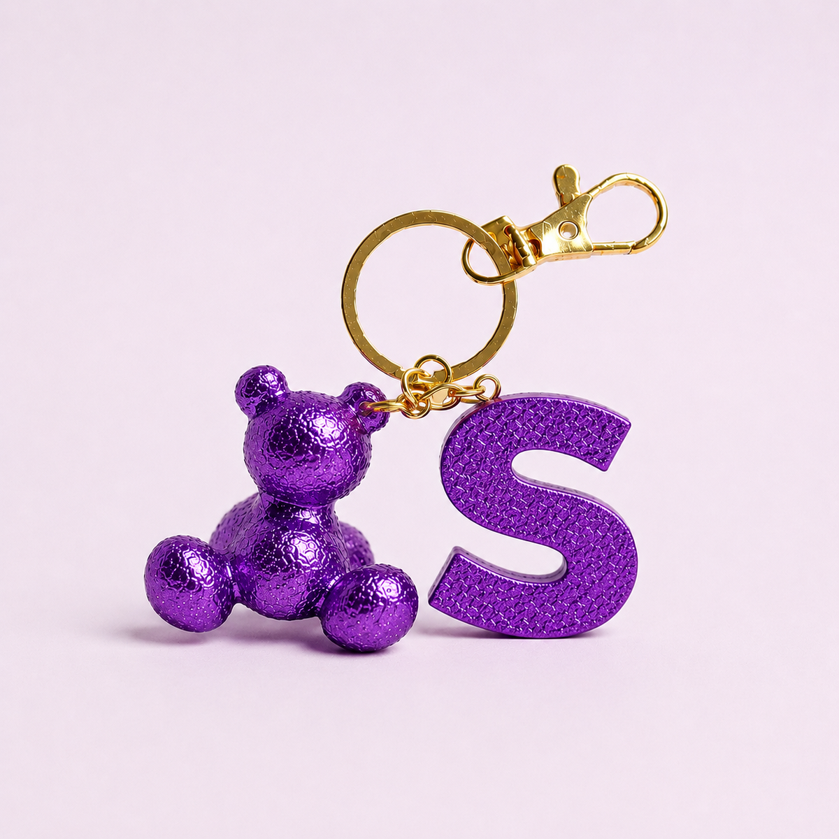 Purple handmade resin bear keychain with the letter S
