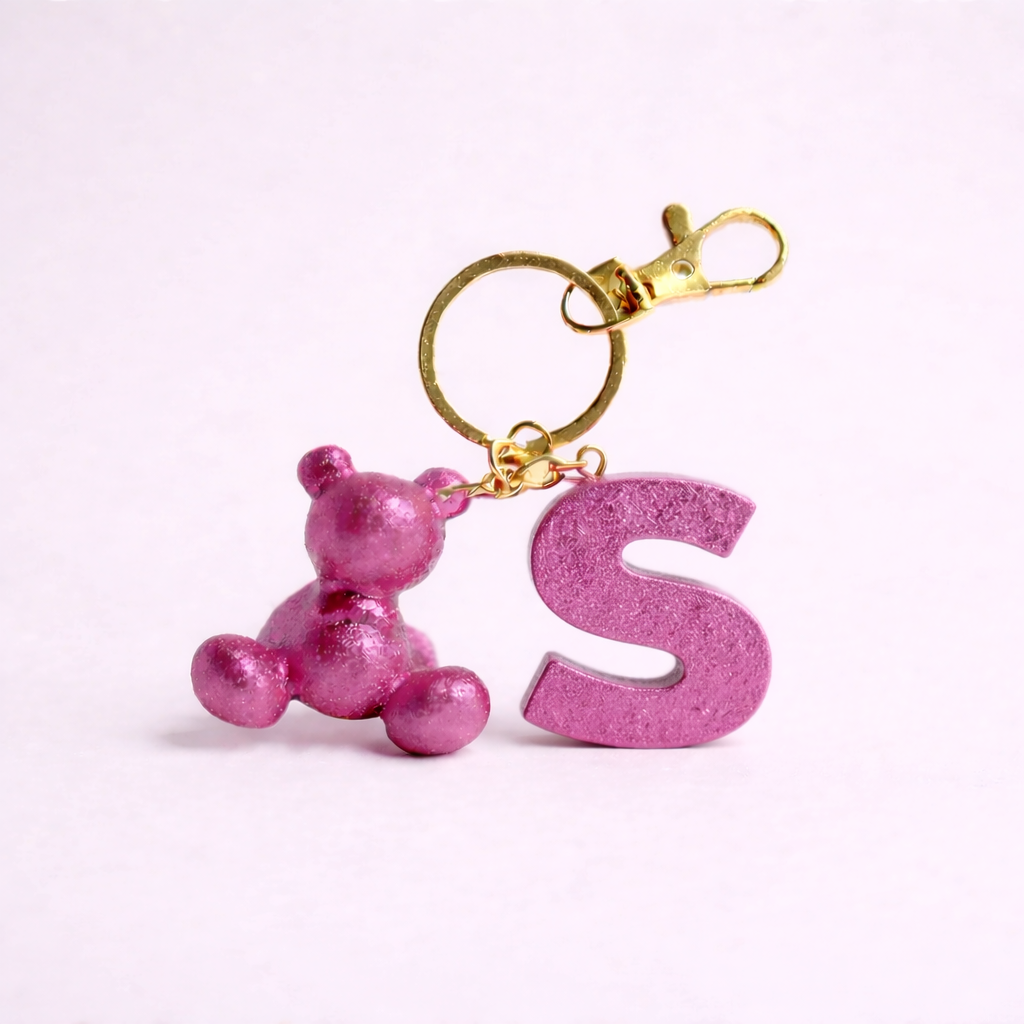 Pink handmade resin bear keychain with the letter S