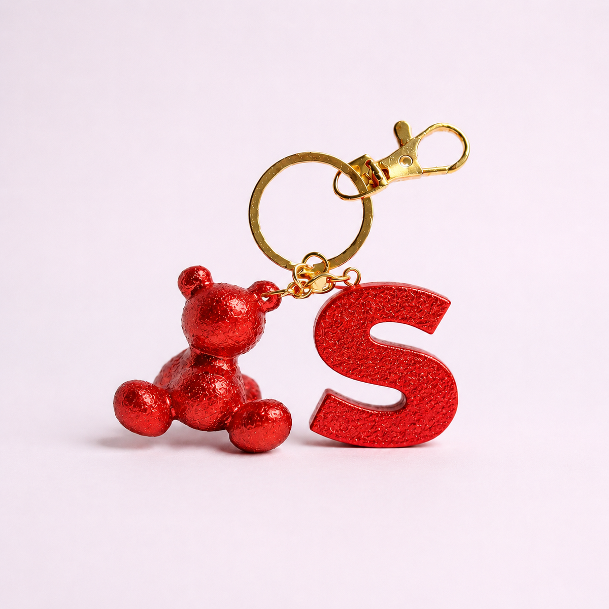 Red handmade resin bear keychain with the letter S
