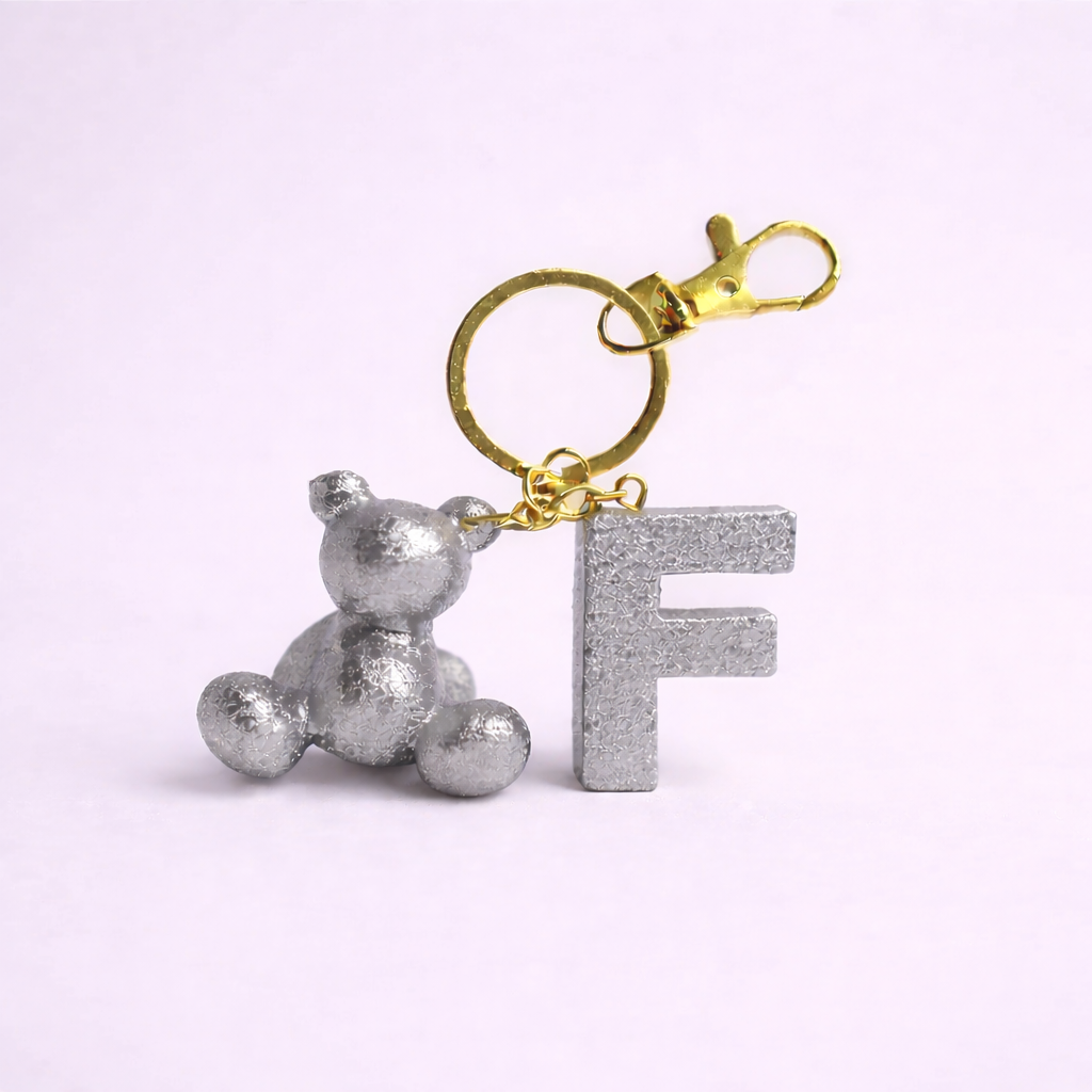 Silver handmade resin bear keychain with the letter F