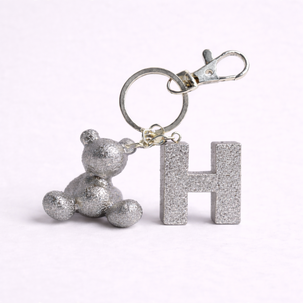 Silver handmade resin bear keychain with the letter H