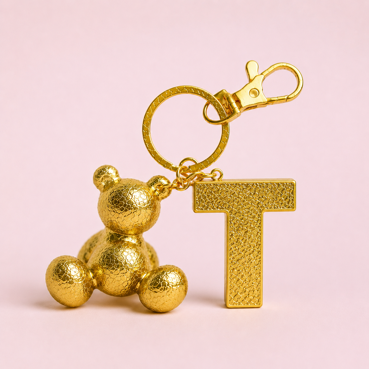 Gold handmade resin bear keychain with the letter T