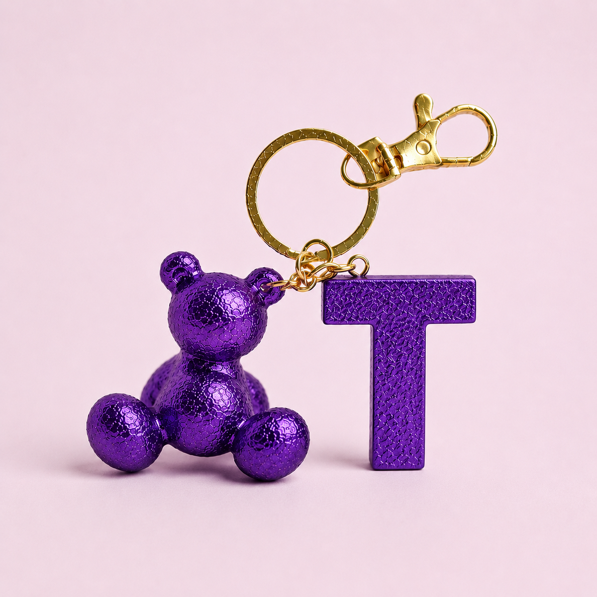 Purple handmade resin bear keychain with the letter T