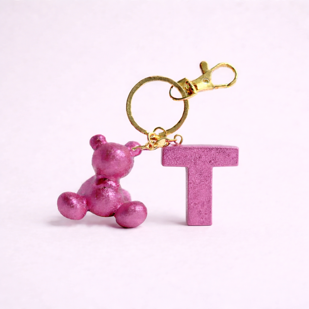Pink handmade resin bear keychain with the letter T