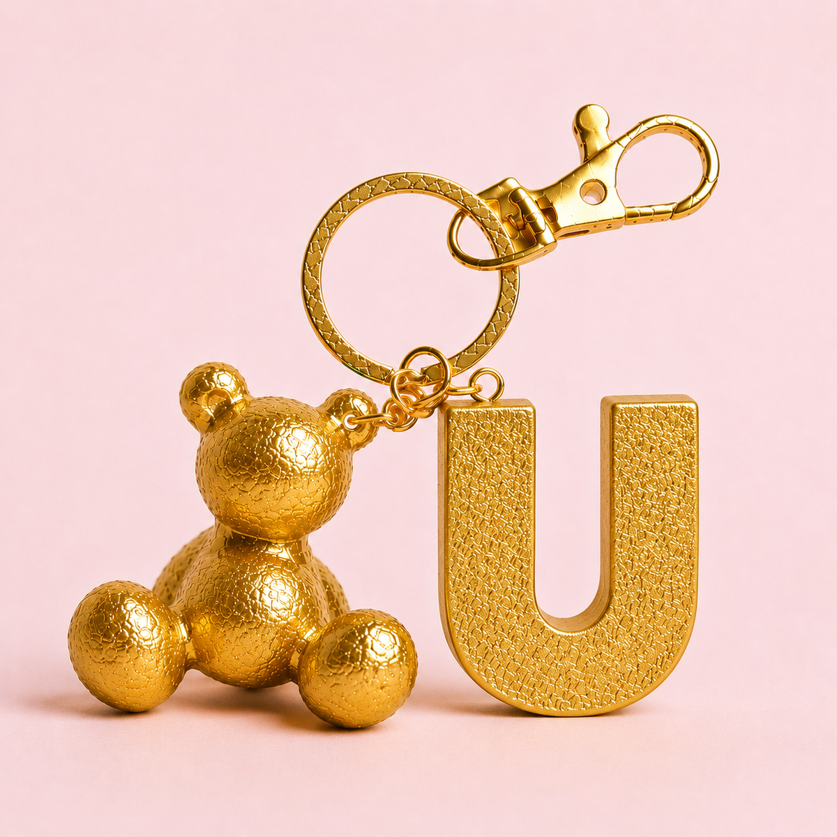 Gold handmade resin bear keychain with the letter U