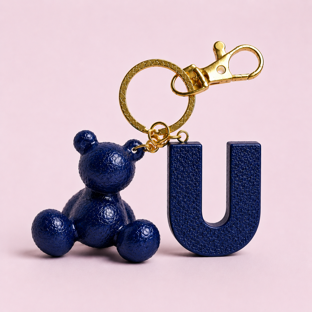 Blue handmade resin bear keychain with the letter U