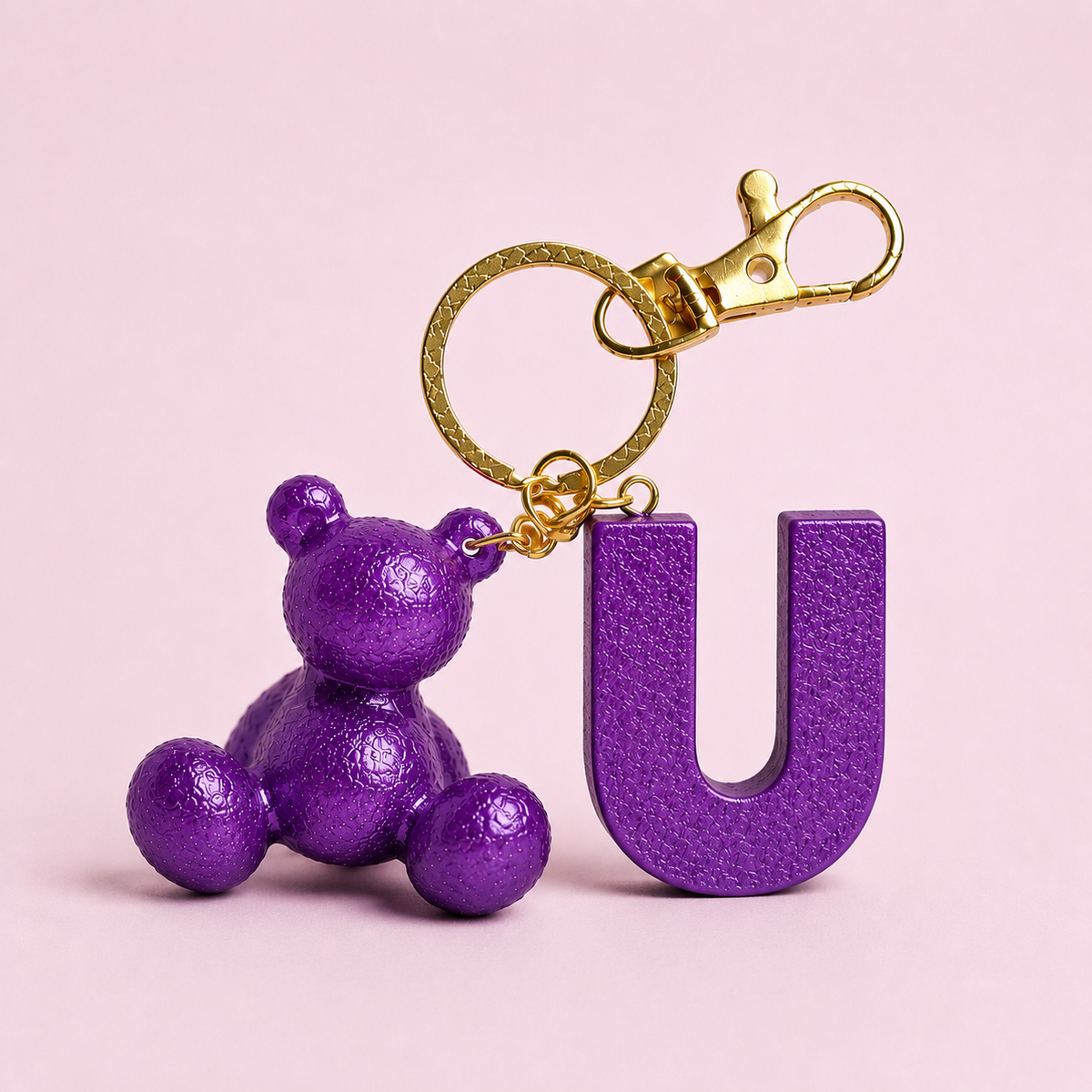 Purple handmade resin bear keychain with the letter U