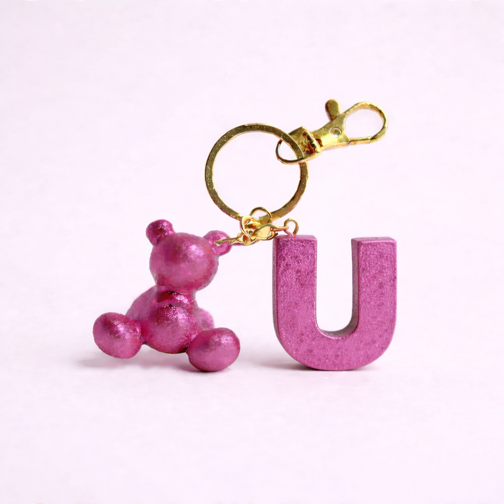 Pink handmade resin bear keychain with the letter U