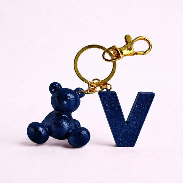 Blue handmade resin bear keychain with the letter V