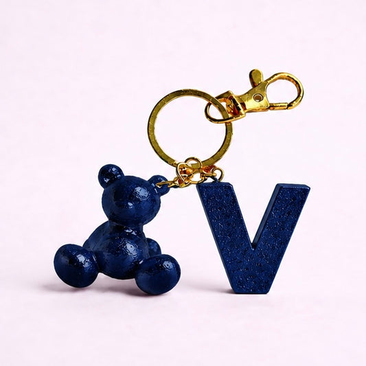 Blue handmade resin bear keychain with the letter V
