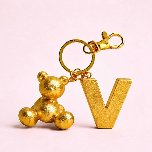 Gold handmade resin bear keychain with the letter V