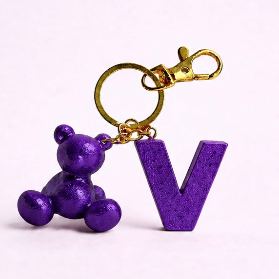 Purple handmade resin bear keychain with the letter V