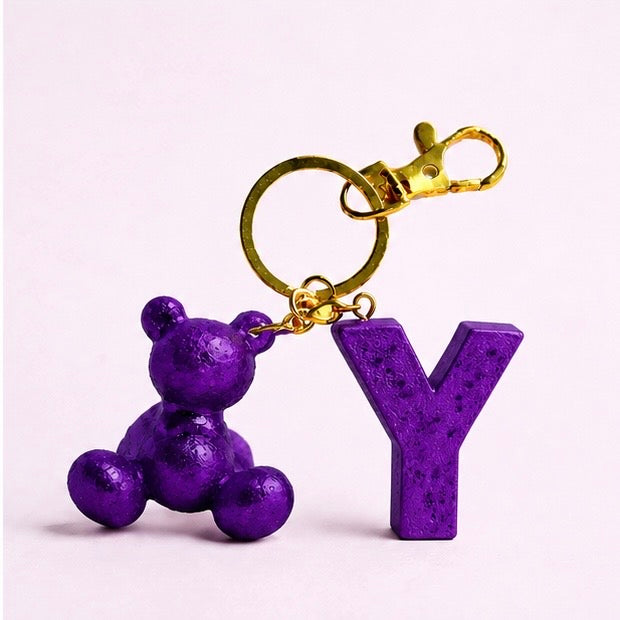 Purple handmade resin bear keychain with the letter Y